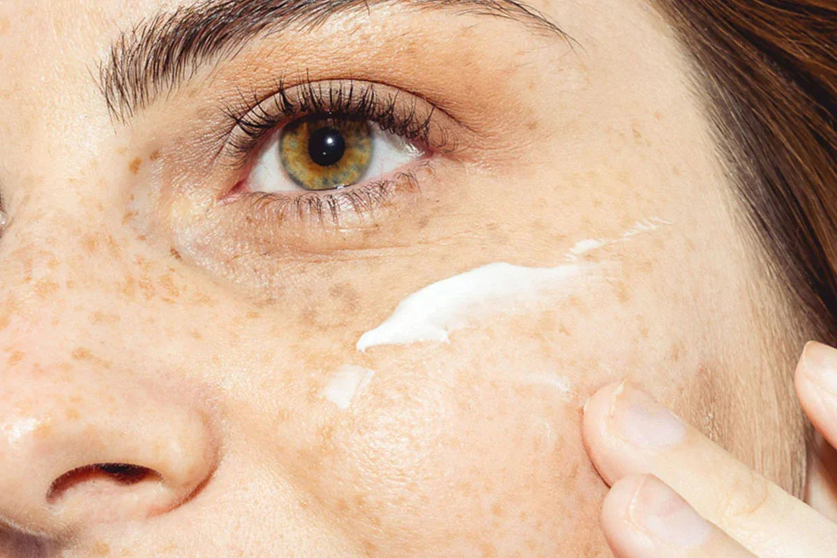 Een vrouw smeert Nordic Cosmetics Dagcrème op haar wang.